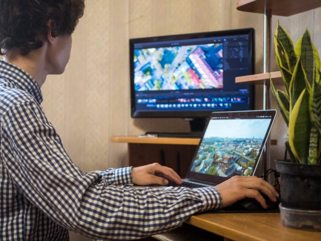 Un jeune homme faisant une recherche sur son ordinateur avant de télécharger Google Earth