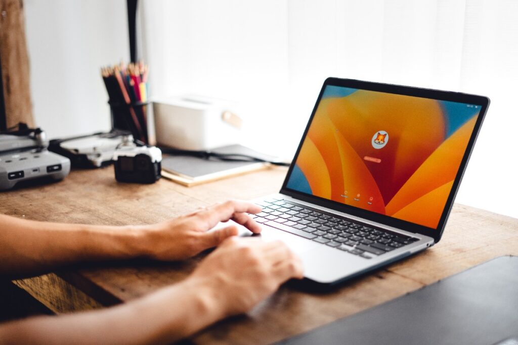 Une personne qui regarde de la TV orange sur son ordinateur portable