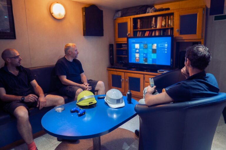 Des hommes regardant la télévision dans une chambre